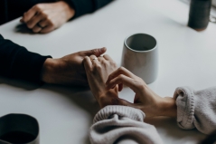 hands holding on a table top