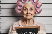 Old lady holding a sign saying guilty?
