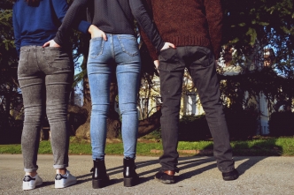 Three people from the back keeping their hands in each other's back pockets